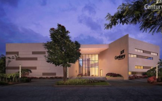 A twilight view highlighting the elegant, warm-lit entrance of Century OneWorld Seraya.